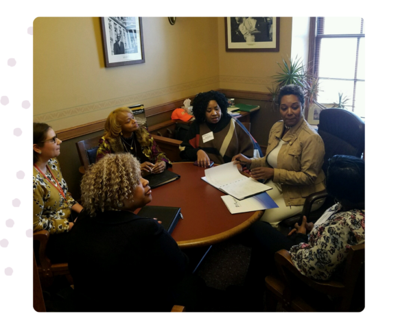 Image of Progressive staff and board members at a congressional meeting