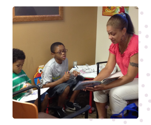 Woman reading to 2 kids